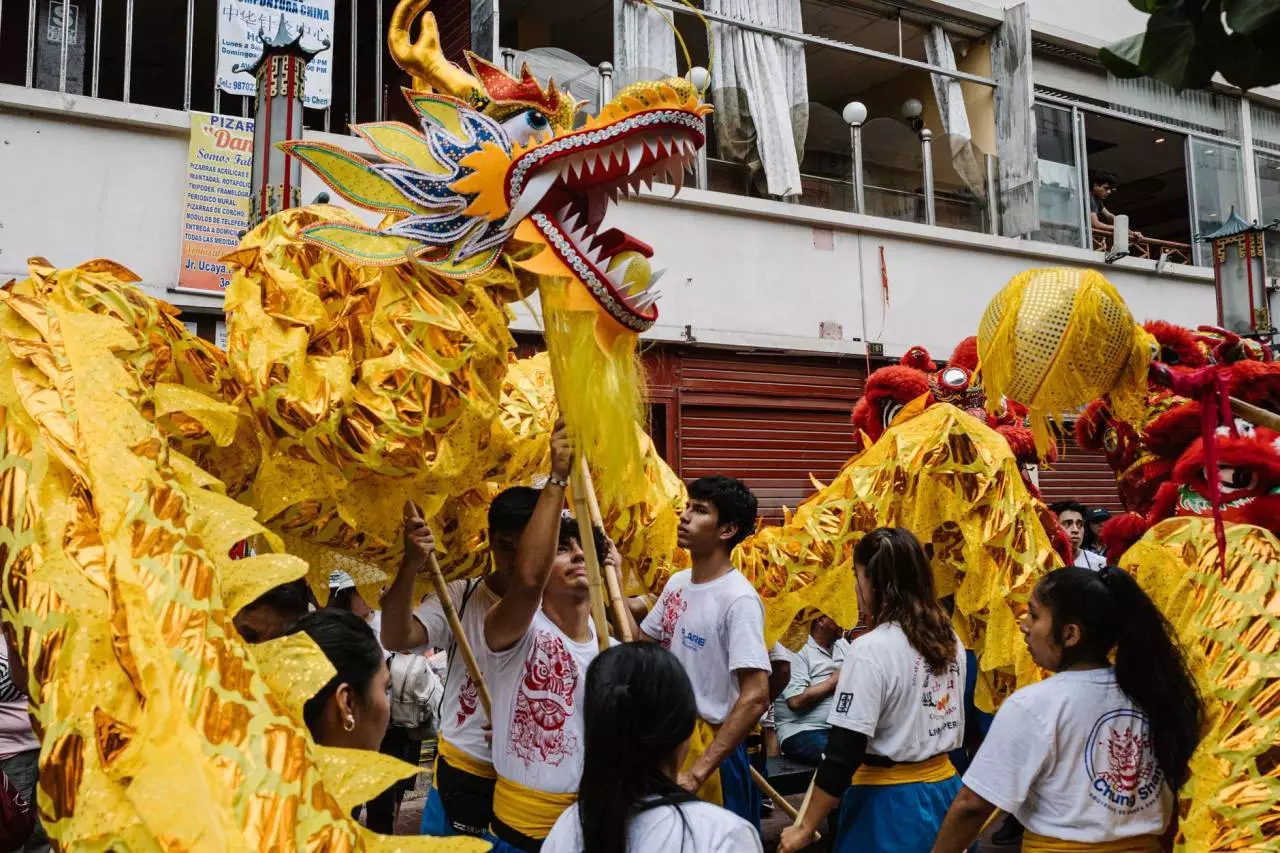 Colorful dragon dance performers at a traditional Chinese festival parade representing the 2026 Yangon Chinese New Year at Thuwunna Stadium