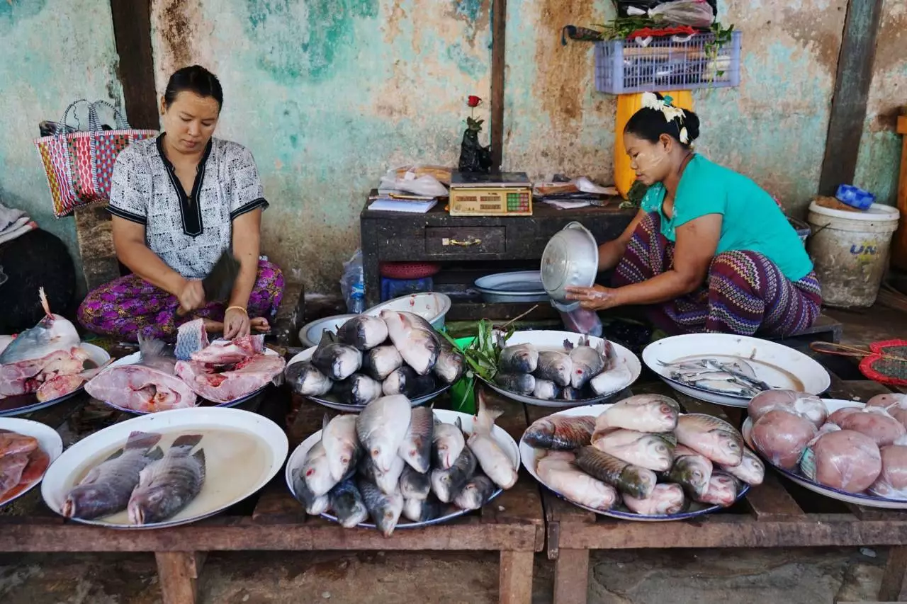 Women at a traditional fish and produce market in Old Bagan Myanmar representing authentic Yangon street food culture and trends in 2026