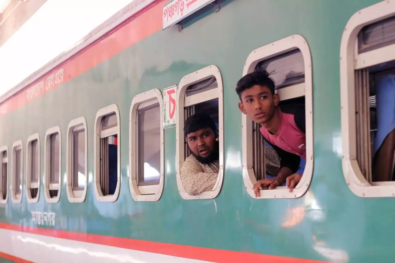 Passengers at an Asian railway station representing the Yangon to Naypyidaw DEMU train schedule and fares guide